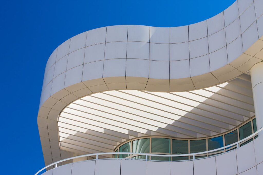 Low-angle view of the Getty Center's modern architecture with curved lines and glass windows.